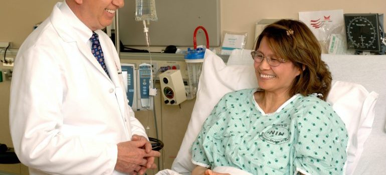 Smiling woman in a hospital bed during her drug detox Lantana Fl